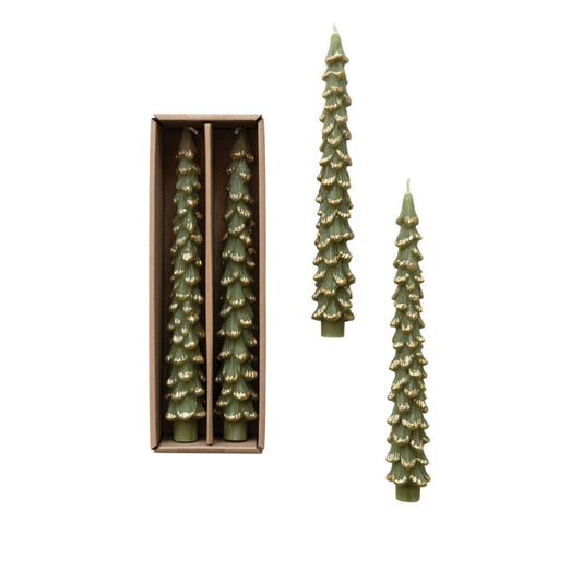 Three pine tree-shaped candles in a muted olive green color with gold glitter accents, shown with two candles standing outside in an open rectangular box and one candle inside.