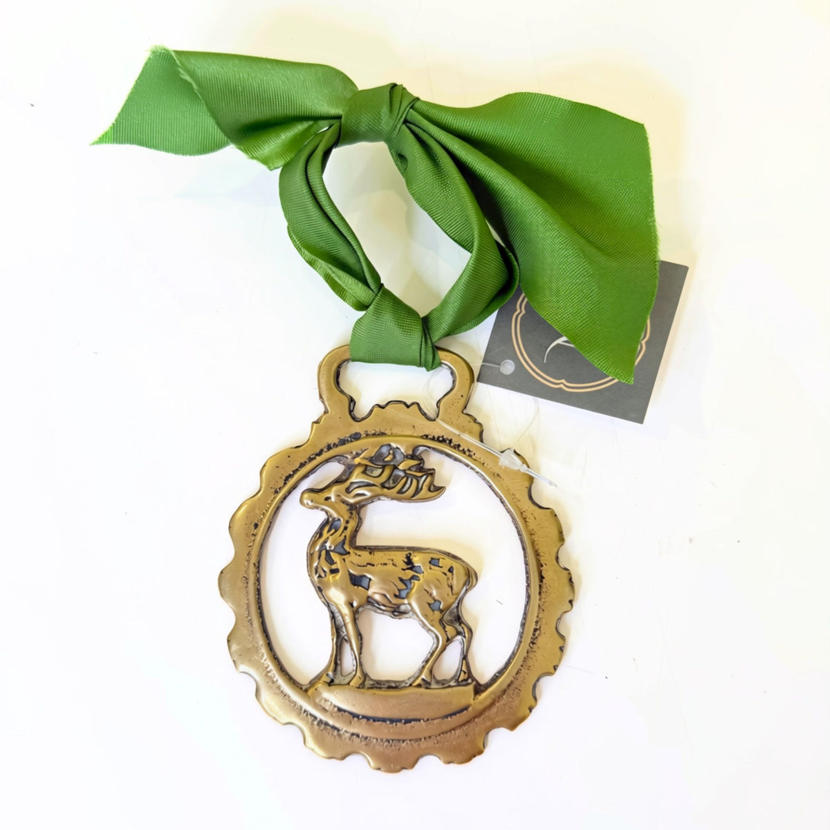 Vintage brass medallion, close-up of cast detail and patina