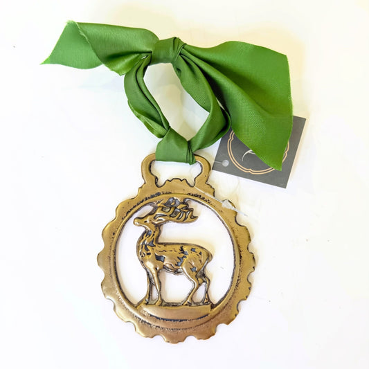 Vintage brass medallion, close-up of cast detail and patina