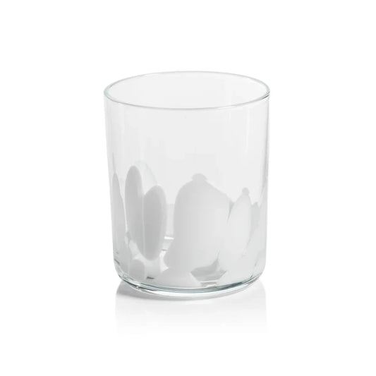 A clear glass tumbler with white spotted pattern near the base, shown on a clean white background with a soft reflection.