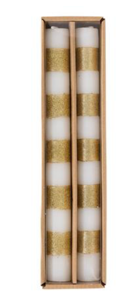 A boxed set of two white taper candles with glittered gold stripes.