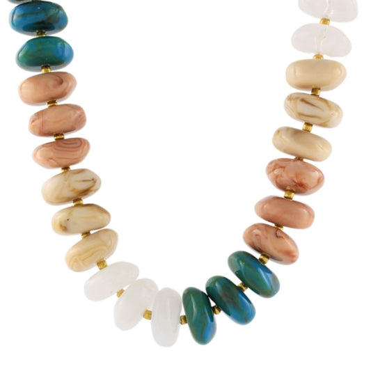 A chunky beaded necklace in white, coral, and teal tones.