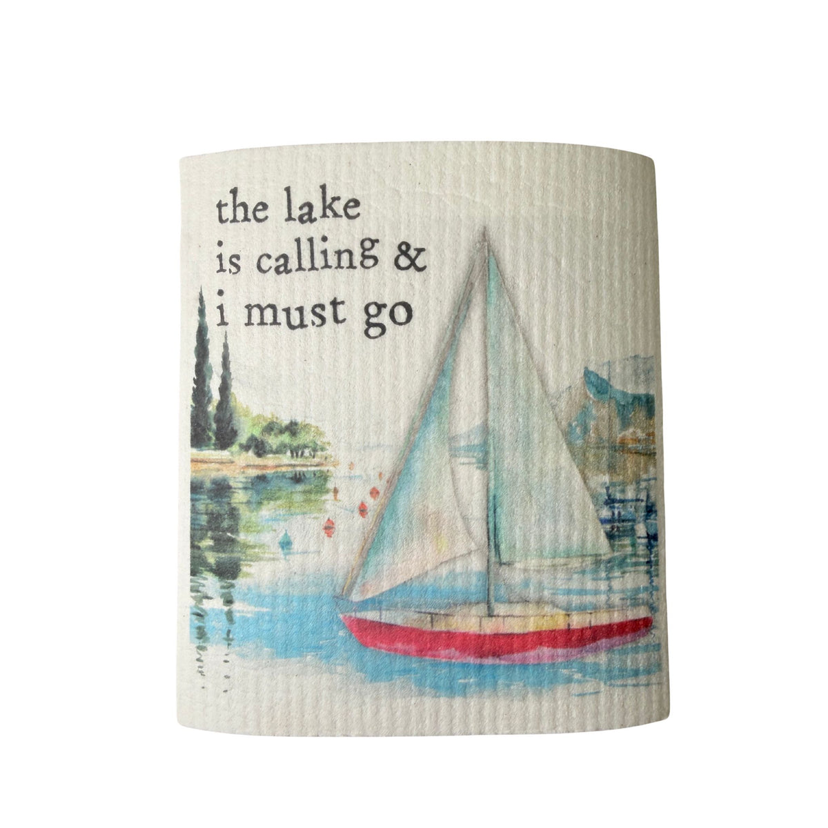 A cream Swedish dishcloth illustrated with a sailboat on the water, reading 'The lake is calling and I must go.'