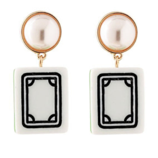 A pair of gold-tone earrings with round pearl-look tops and white rectangular mahjong tile drops with a black double-line border.