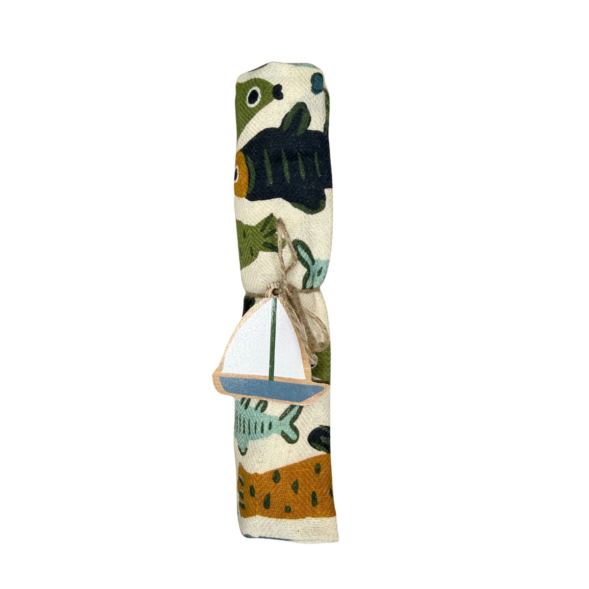 A rolled cream linen tea towel printed with fish, tied with jute twine and a hand-painted wooden sailboat charm.