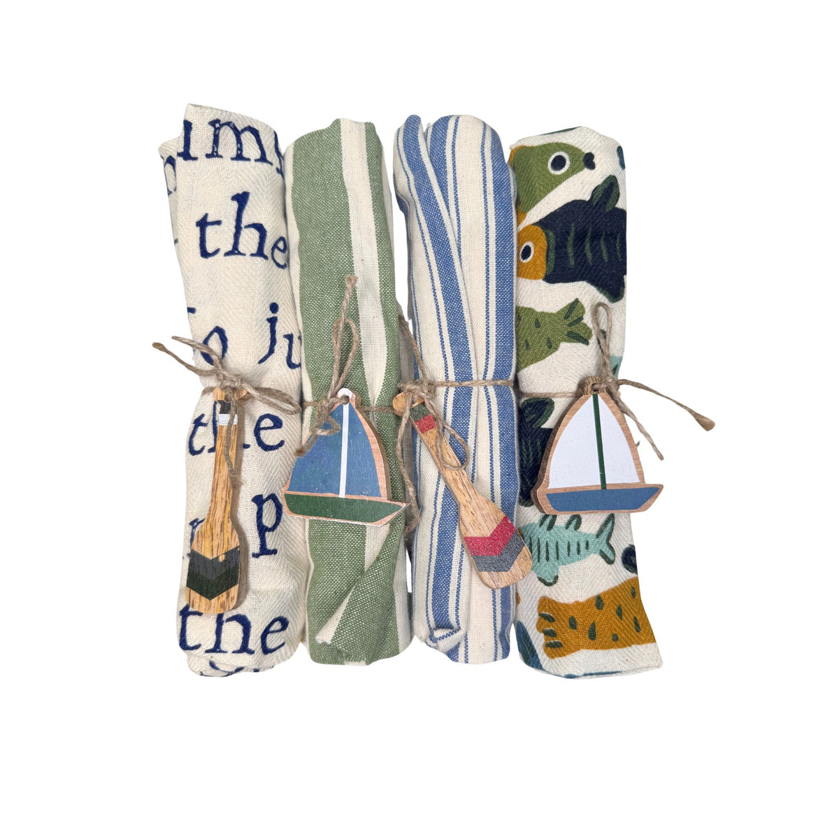 A rolled cream linen tea towel tied with jute twine and a hand-painted wooden charm, close-up detail.