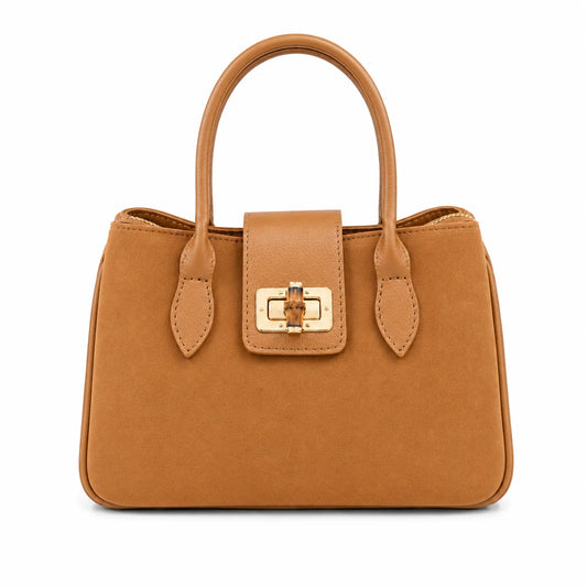 Camel suede satchel with smooth leather trim, double top handles, and a gold-tone turn-lock closure on the front flap.