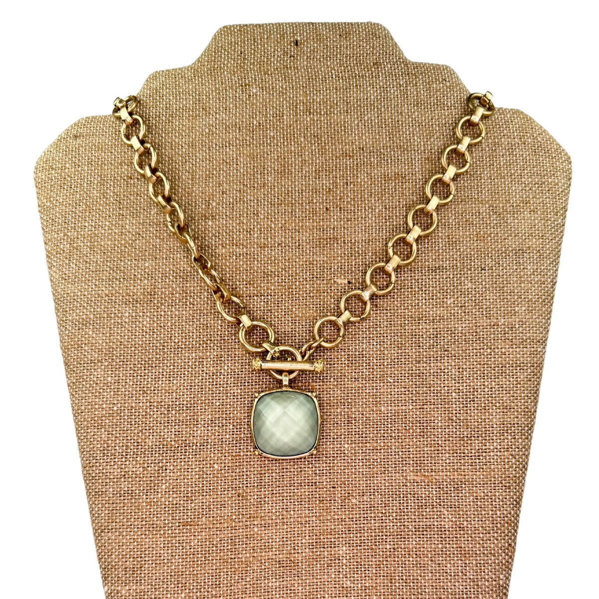 Gold toggle necklace with a square stone pendant in a plaid pattern