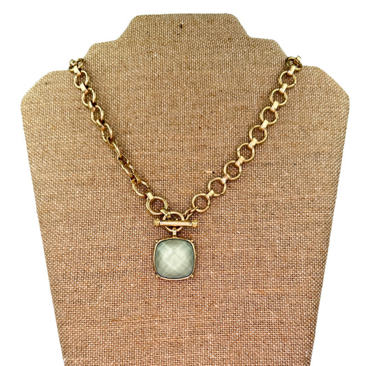 Gold toggle necklace with a square stone pendant in a plaid pattern