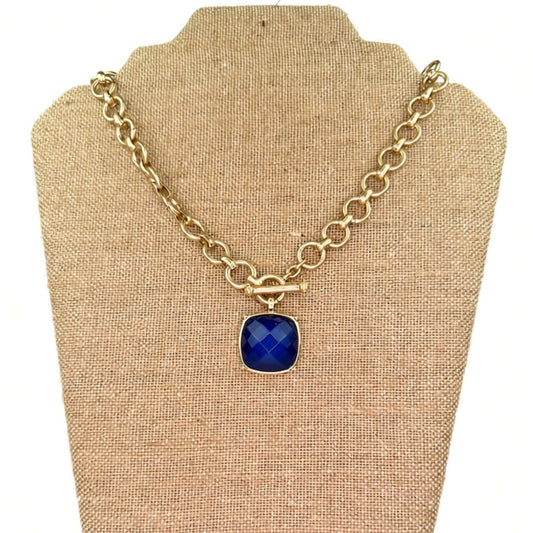 Gold chain-link necklace with a toggle clasp and stone pendant