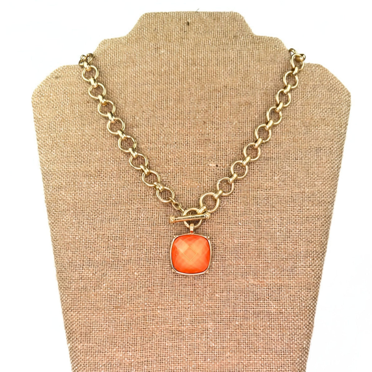 Gold toggle necklace, close-up of stone pendant detail