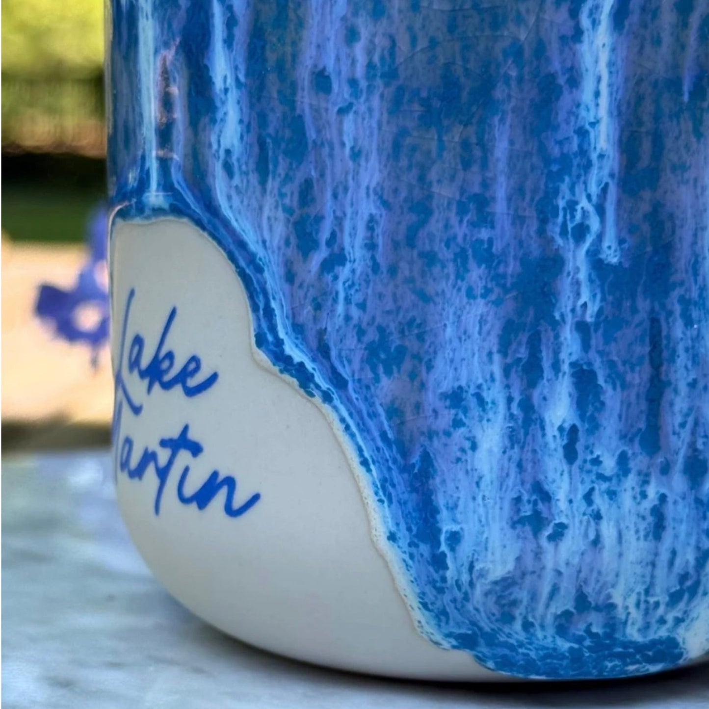 Close-up of the Lake Martin cobalt-and-white waterfall glaze on the handmade ceramic Grande cup