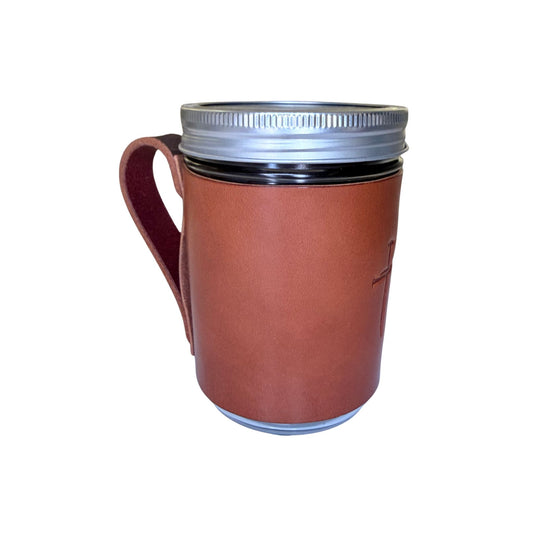 A brown leather-wrapped mason jar mug with a silver metal screw-on lid and a leather handle, shown on a plain white background.
