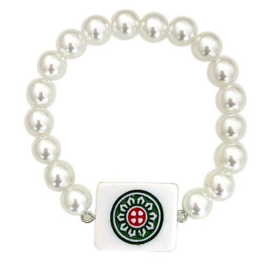 A white pearl-bead bracelet with a rectangular white mahjong tile charm printed with a green and red circular flower design.