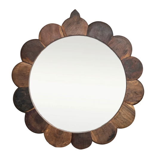 Round mirror with a wooden, petal-like frame on a white background