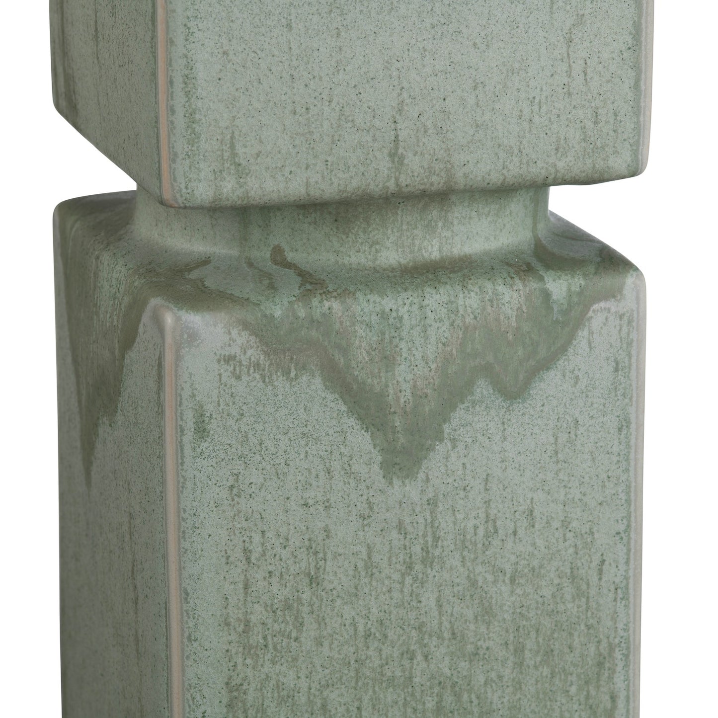 Green ceramic lamp closeup with textured surface on a white background