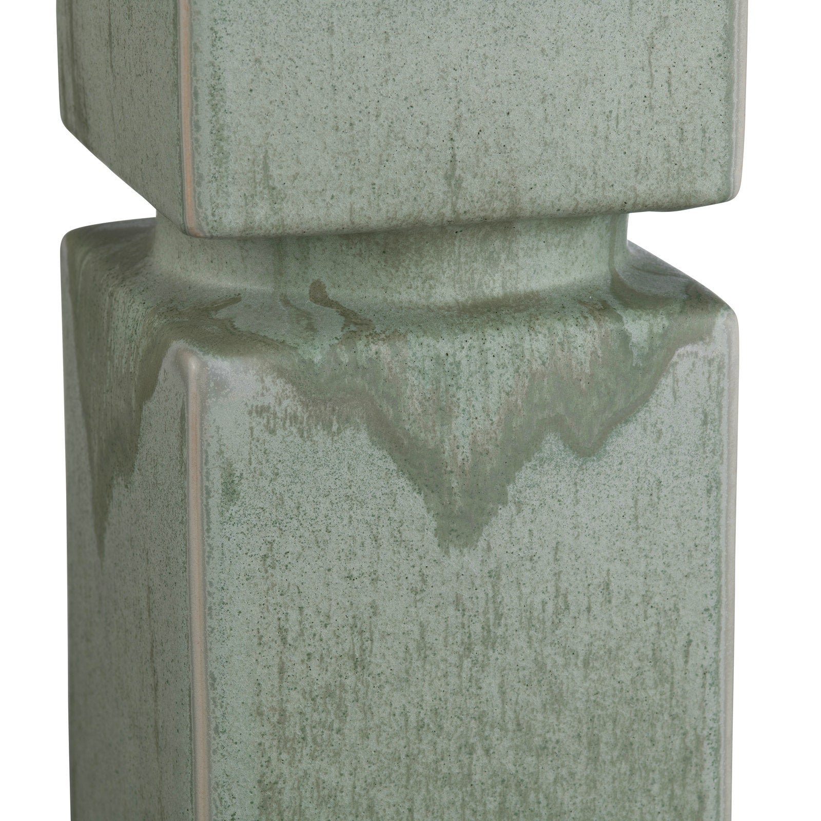 Green ceramic lamp closeup with textured surface on a white background