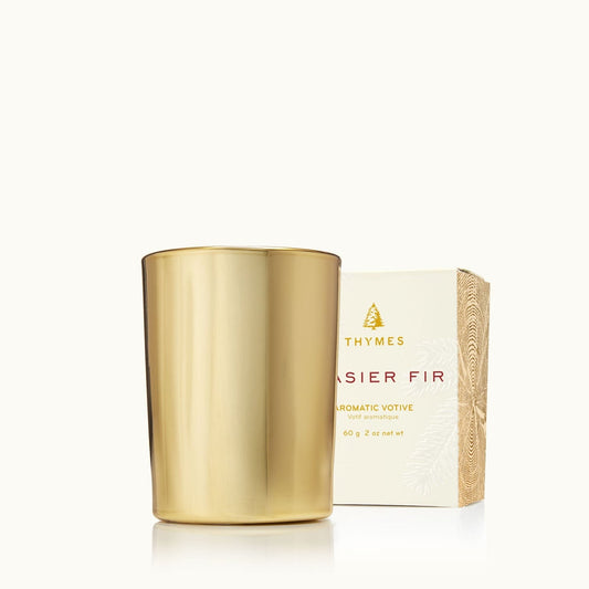 Gold votive candle and its packaging on a white background