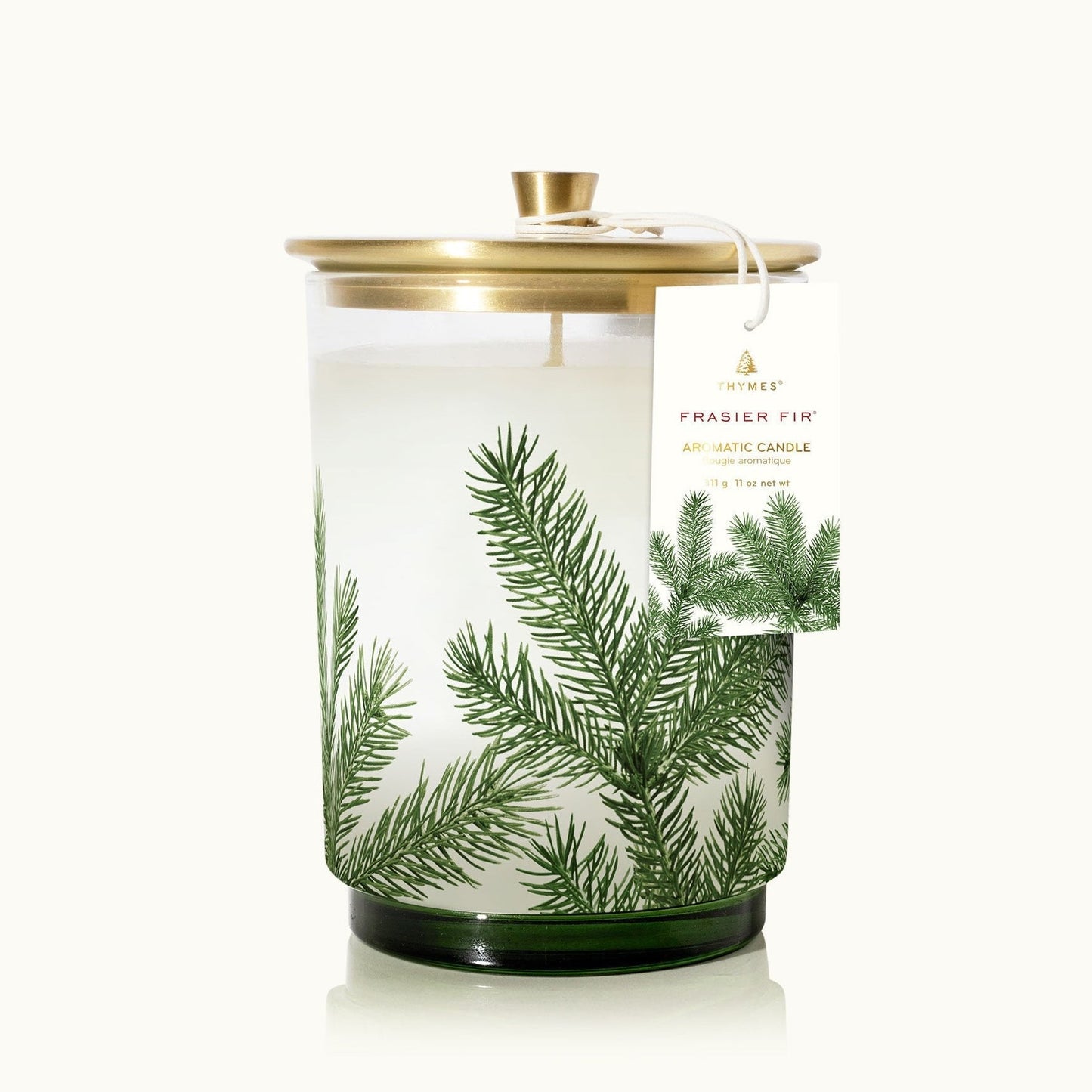Fragranced candle with green foliage design on a white background