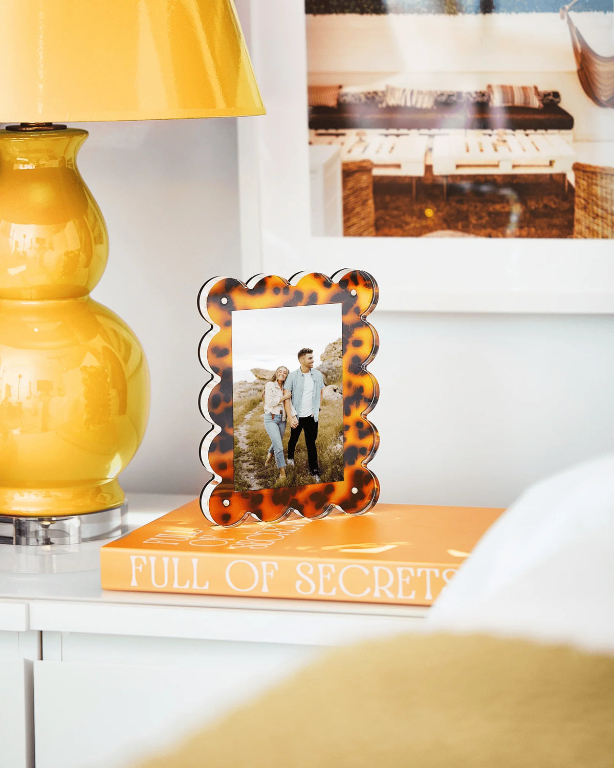 Tortoiseshell scalloped acrylic photo frame with a photo inserted