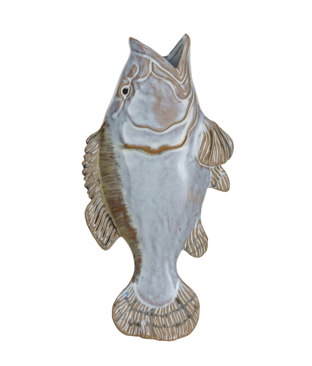 White and tan stoneware wall vase shaped like a fish, hung on a wall